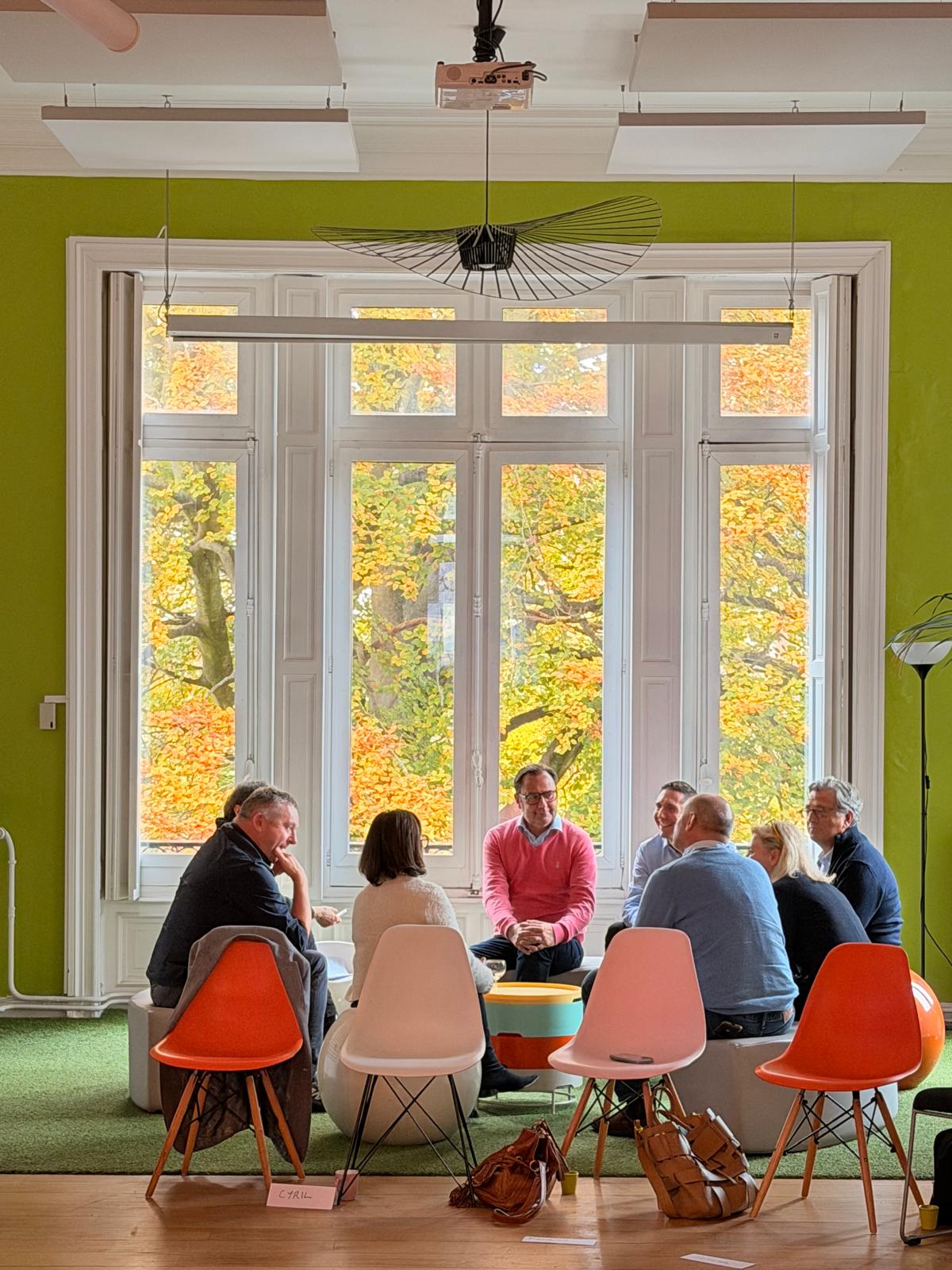 Groupe en séminaire à La Maison d'Alfred, échange en cercle dans un salon lumineux